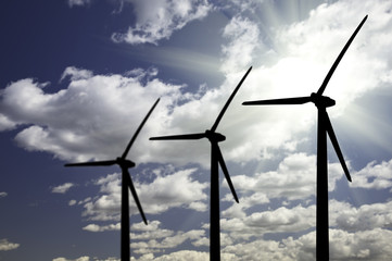 Silhouetted Wind Turbines Over Dramatic Sky