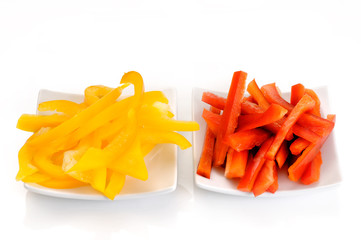 yellow pepper and red pepper strips on a dish - 30994949
