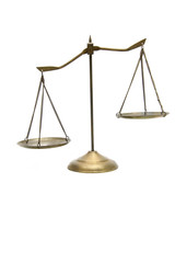 unbalance of golden brass scales of justice on white