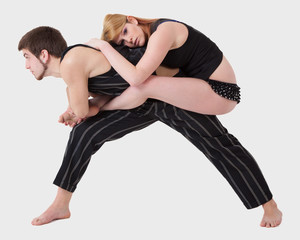 Young Couple Practices Acrobatic Balance
