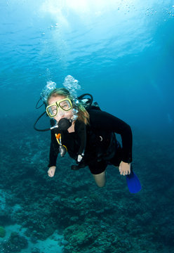 sexy scuba diver poses underwater
