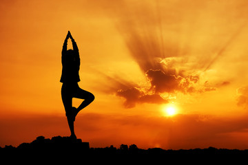 Silhouette of a beautiful Yoga woman in the morning