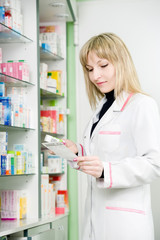 Pharmacy chemist woman in drugstore