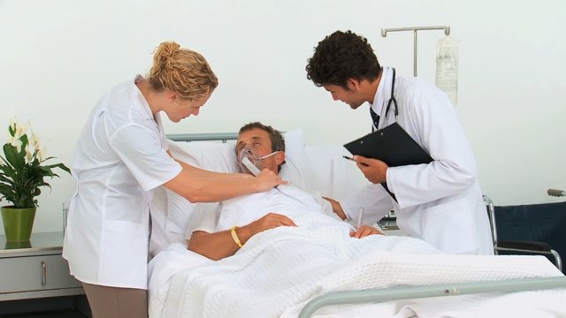 Doctors examining an unconscious man