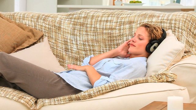 Curly blonde woman listening to music
