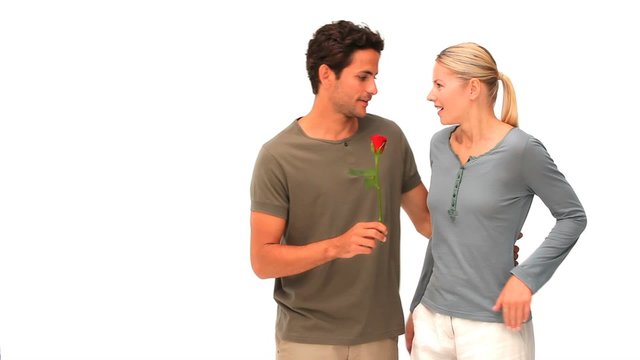 Man giving a red rose to his wife