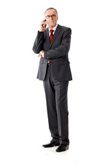 Casual senior business man phoning, isolated