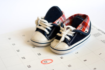 Due date in the calendar and the baby shoes