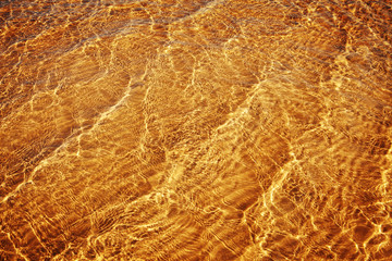 Fototapeta na wymiar golden sweet sea waves at sunset, close up