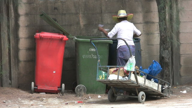Asian Lady Going Through The Garbage