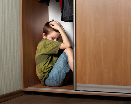 Sad boy, hiding in the closet