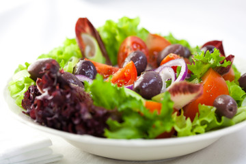 Delicious vegetable salad with marinated greek olives