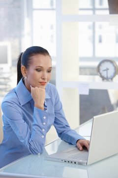 Smart businesswoman working on laptop computer
