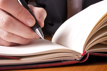 hand pen paper table fingers notebook