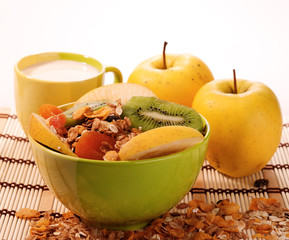 cuisine still-life. muesli with milk and fruits over white