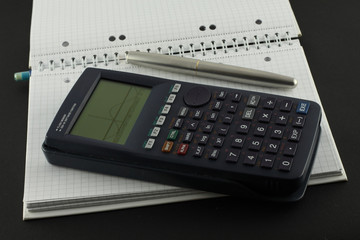 Open notebook with pen and calculator.