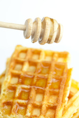 delicious Belgian waffles and stick to honey isolated on white