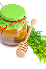 stick to hohey  and  jar of honey  isolated on white