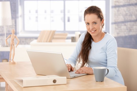 Attractive female browsing internet at home