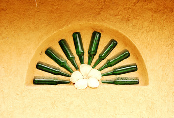 Pattern of buried bottles on the wall