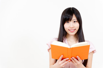Naklejka premium beautiful asian woman reading a book