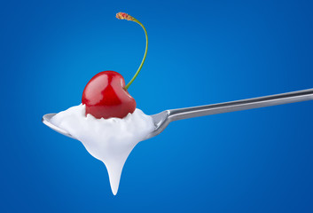 Isolated yogurt. Spoon of natural yoghurt with cherry on top over blue background