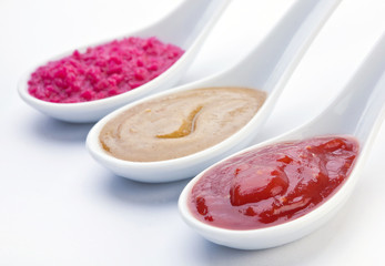 Sauce spoon closeup on white