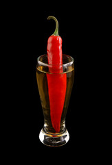 Cocktail with chilli pepper isolated on black