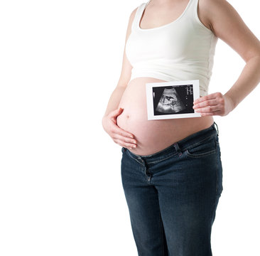 Pregnant woman holding ultrasound picture