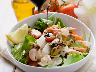 balsamic vinegar over mixed seafood salad
