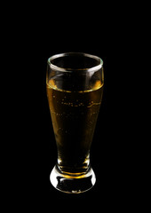 Glass of alcohol isolated on black