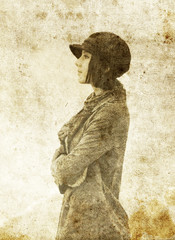 Fashion girl in cap. Photo in old image style.