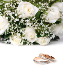 wedding rings and roses bouquet