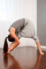 woman doing flexibility exercise in room