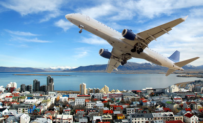 Airplane above Reykjavik town. Island - obrazy, fototapety, plakaty