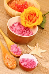 Obraz na płótnie Canvas Bath aromatic salt, rose and sea stars on wooden background