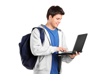 A portrait of a male student working on a laptop