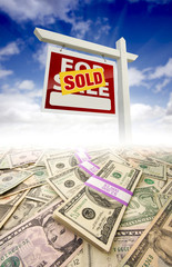 Stacks of Money Fading Off and Sold For Sale Real Estate Sign