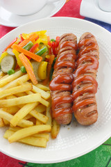 Sausage with french fries and vegetables