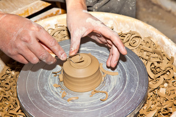 hands working on pottery wheel