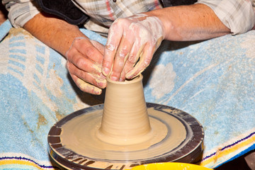 hands working on pottery wheel