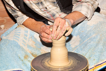 hands working on pottery wheel