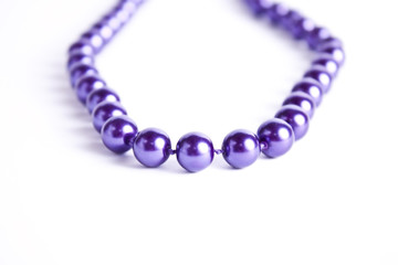 violet pearl necklace on white background