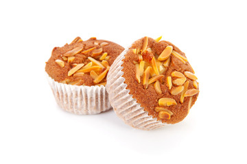 three biscuit cupcakes with nuts over white background