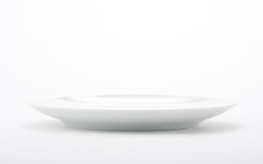 White empty dish on seamless white background.