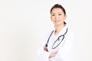 Fototapeta na wymiar young Japanese female doctor smiles with Folding arms