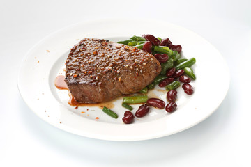Grilled steak with stir-fried string beans  on white background