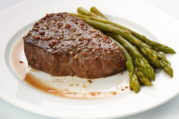 Grilled steak with Green asparagus on white background