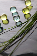 Closeup of bath pearls on wet slate
