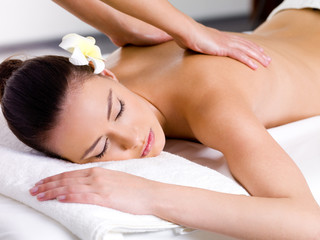 Beautiful woman having relaxing massage  in spa salon